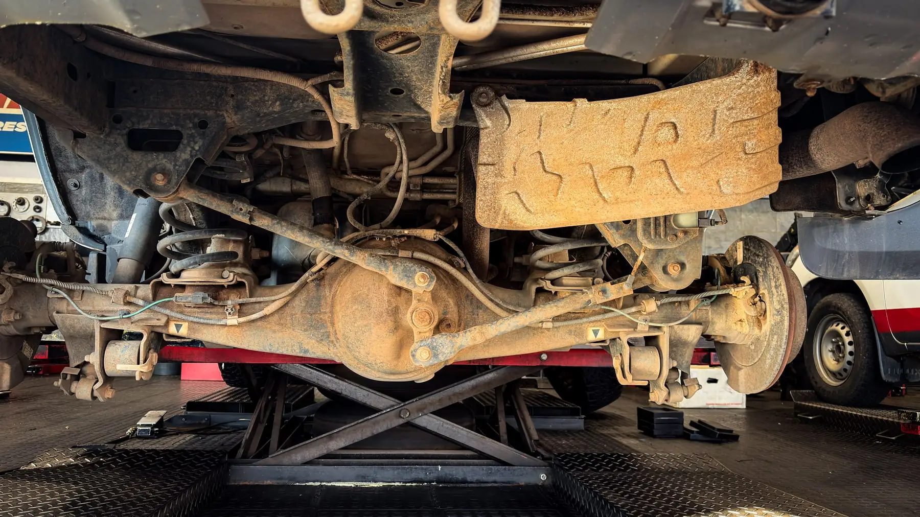 The underside of a four wheel drive showing the differential and driveline