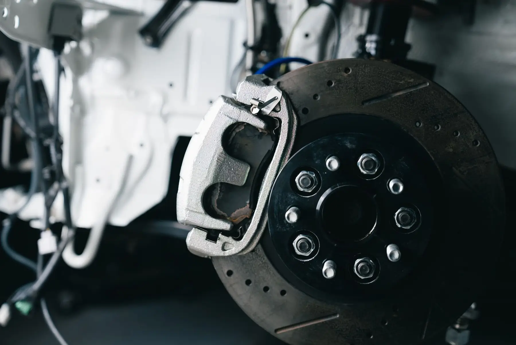 A brake rotor and caliper with the wheel removed