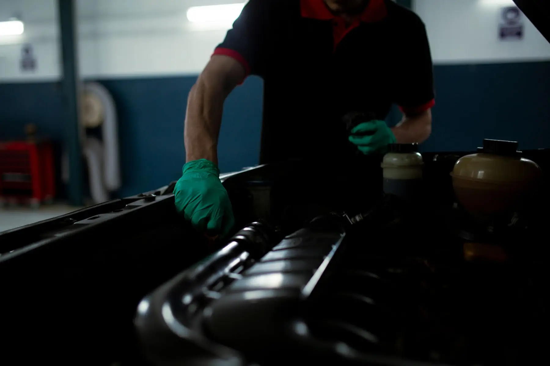 A service book open on a workbench beside a torque wrench