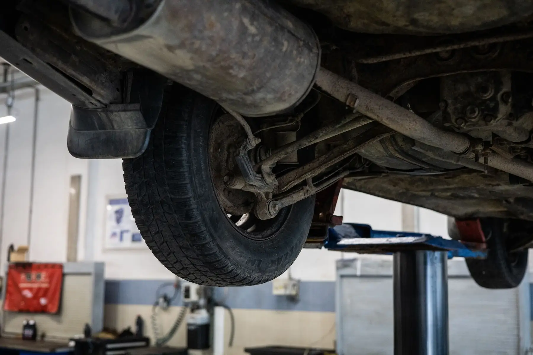 A front suspension strut and lower control arm with the wheel removed