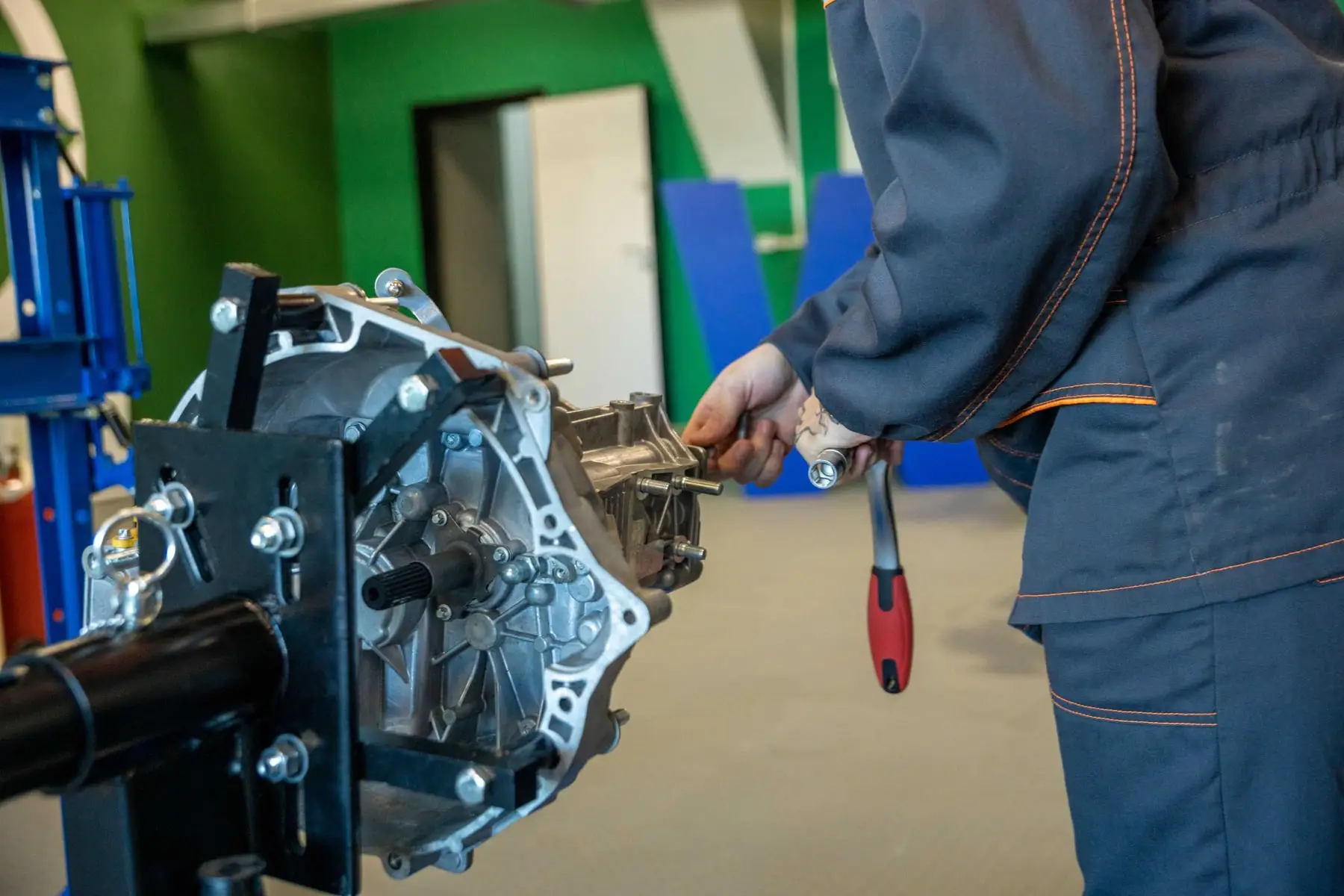 A gearbox removed from a vehicle and supported on a transmission jack